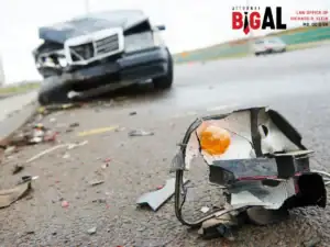 Broken car headlight and debris after a road crash